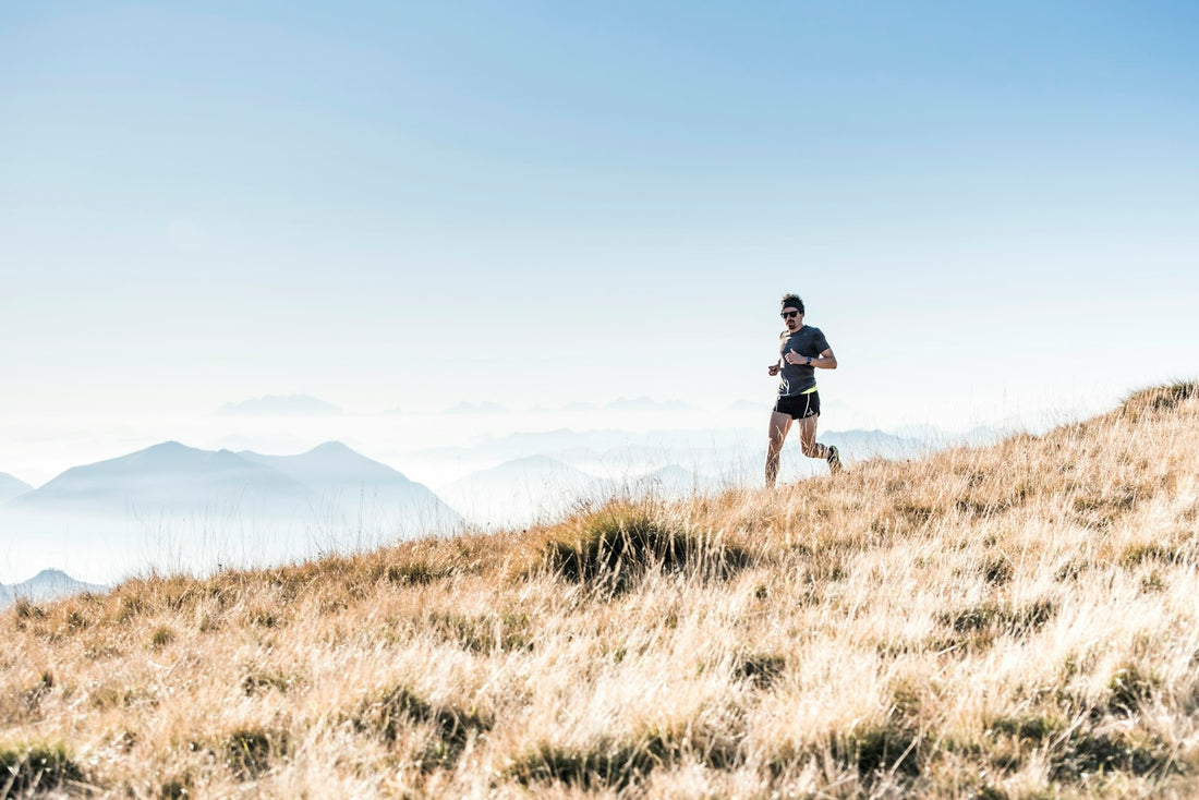 A trail runner on a mountain ridge during an ultra distance run