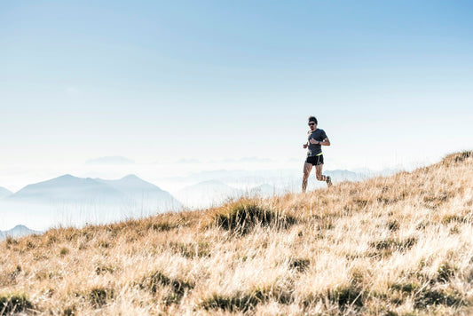 A trail runner on a mountain ridge during an ultra distance run