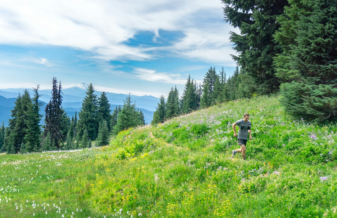 A man running outdoors across an open grassy field
