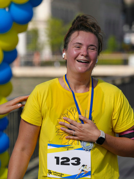 Smiling runner wearing a race medal around her neck