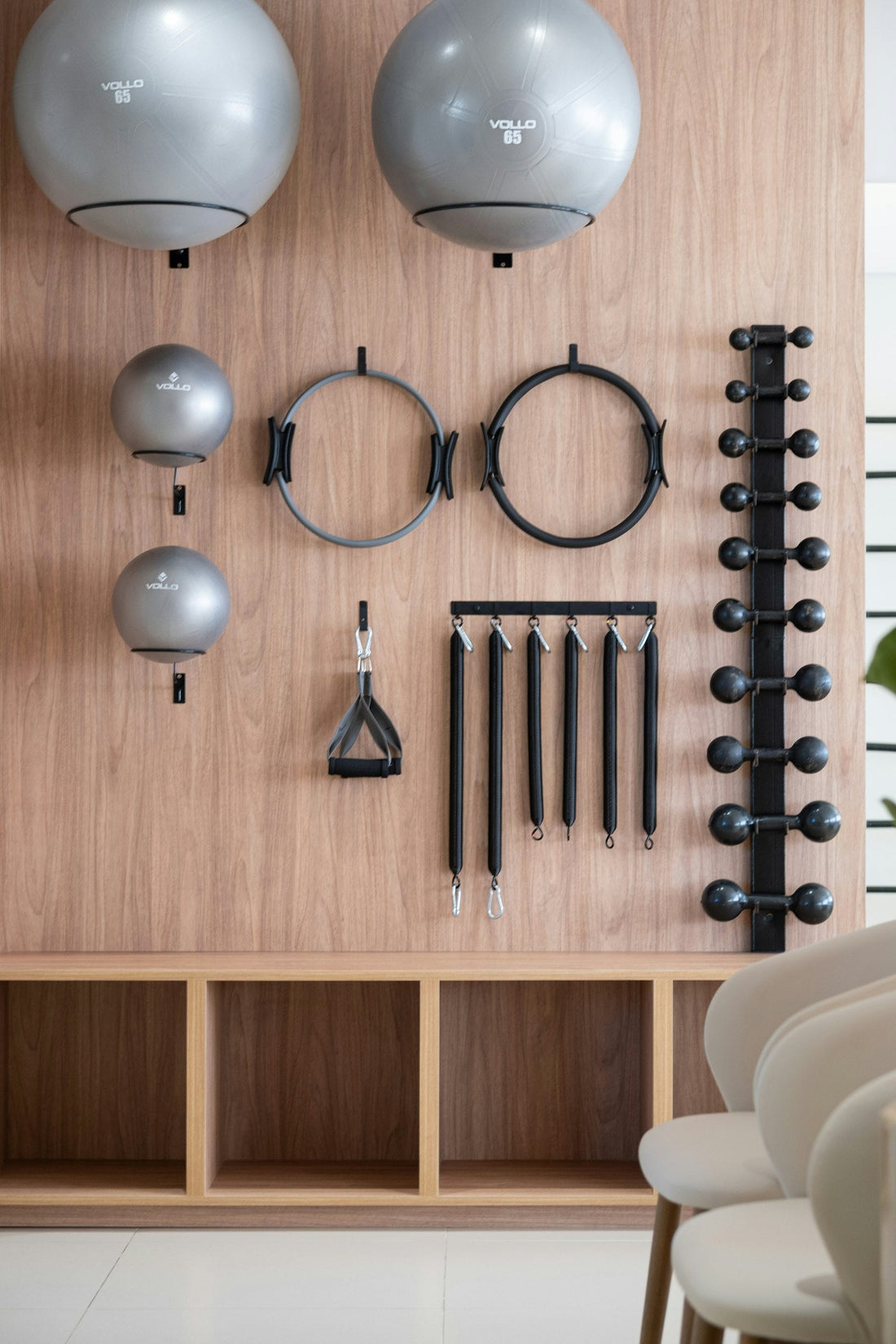 Home gym with equipment neatly organised on a wooden wall