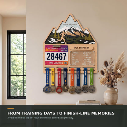 Mountain runner medal holder with race stats board – in a bright living room