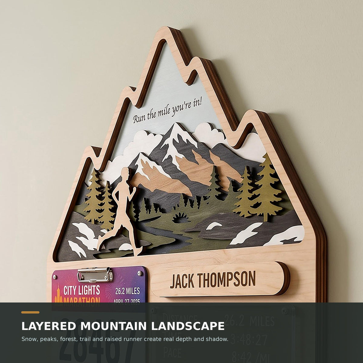 Mountain runner medal holder with race stats board – layered mountain landscape close-up