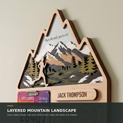 Mountain runner medal holder with race stats board – layered mountain landscape close-up